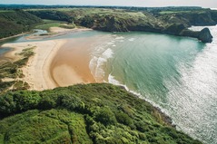 coastal bay with distinctive rock formations Three Cliffs Bay Gower