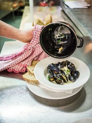 seafood mussels served in a bowl with  bread