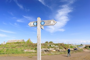 signpost for Anglesey Coastal Path at Cemlyn Bay