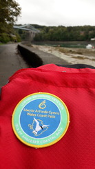 woven badge with Isle of Anglesey coastal path embroidered on