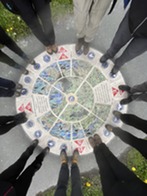 people's feet around a mural artwork on the floor