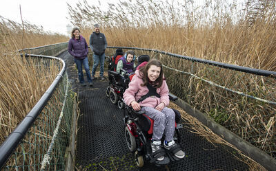 Visitors using an accessible boardwalk Newport Wetlands RSPB