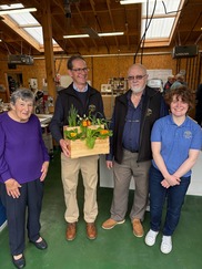 Members of The Shed at Collingham with flowers they have arranged