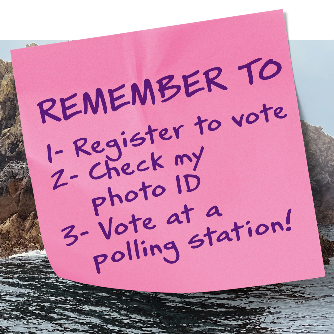 A pink post it note with writing on it, saying 'Remember to 1 - Register to vote 2 - Check my photo I.D. 3 - Vote at a polling station!