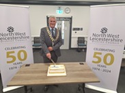 NWLDC Chairman 2024 Councillor Kenny Horn, cuts the 'NWLDC celebrating 50 years' cake at Annual Council 