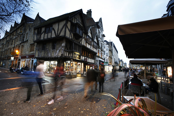People milling around Cornmarket Street at dusk 