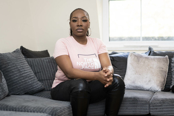 Woman sits on the edge of a grey sofa. Credit: Aaron Chown/PA Wire/Centre for Homelessness Impact 