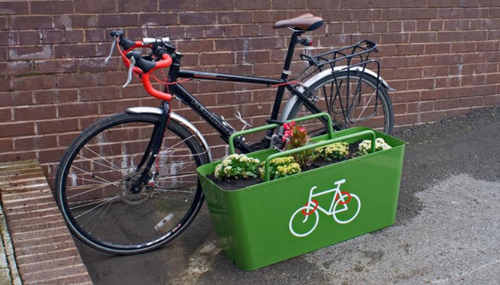 Image of a bike attached to a planter that is a bike stand 