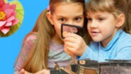 Kids inspecting an item that on is holding up 