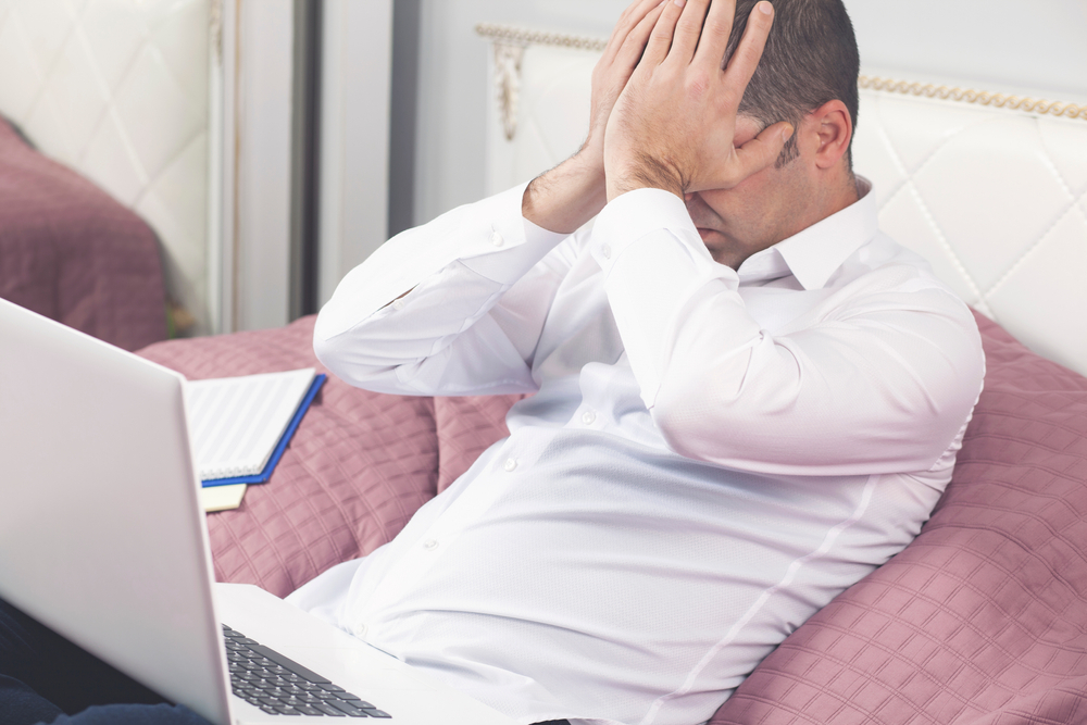 Man looking frustrated and upset on his computer