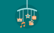 Image of cot mobile with icons from film and music dangling 