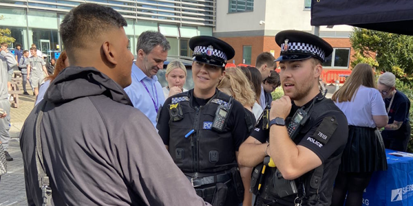 Officers talk to a student about a career in policing.