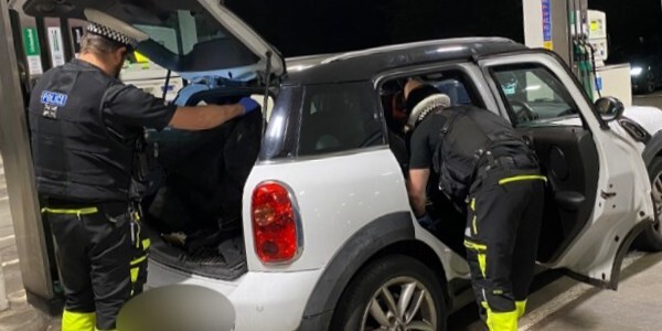 Two officers searching a mini car