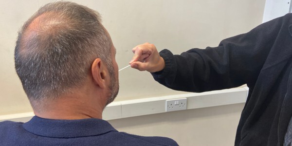 Man having a mouth swab taken