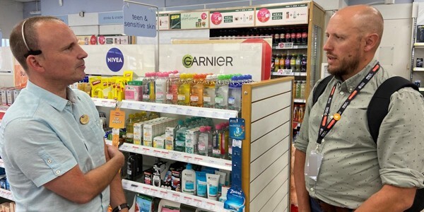 Member of the Essex Police Business Crime Team talking to a retailer in a shop