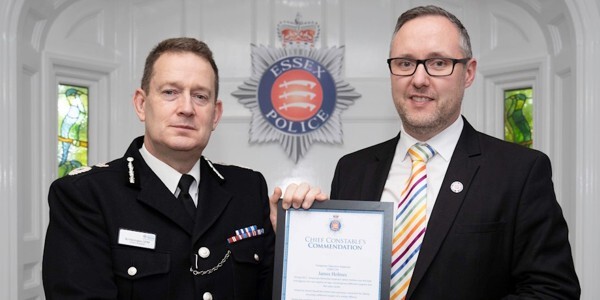 Detective Inspector James Holmes receives his Commendation certificate from Chief Constable Ben-Julian Harrington, left