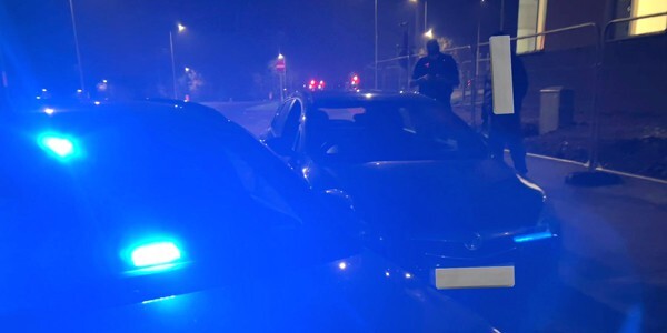 Unmarked police car next to Astra at night. Blue lights illuminating the scene