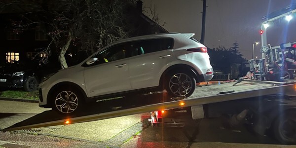 vehicle on back of recovery truck
