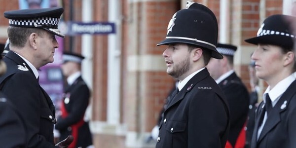 Chief Constable BJ Harrington talks to two of the new recruits during a passing out parade at HQ