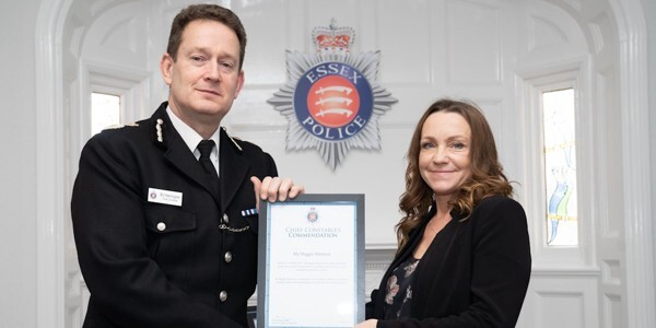 Maggie Harrison receives her Commendation certificate from Chief Constable Ben-Julian Harrington