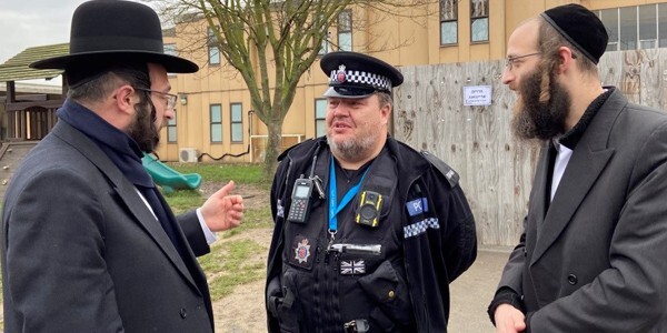 Lay community leader Joel Friedman, left, and Mike Gold, from the Haredi Community, right, with PC Ian Risden.