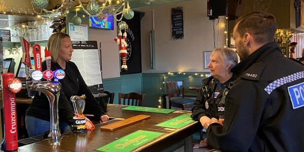 Essex Police licensing officer Steve Bennett talking with staff at Shakers Bar in Harwich, who are supporting the Pubwatch scheme