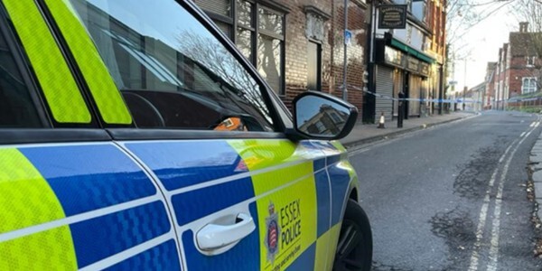 Police car with police cordon further up the street