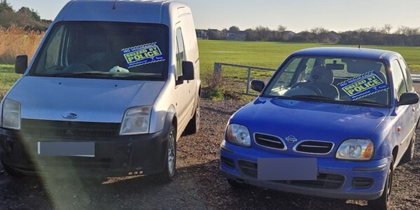 A seized white van and car