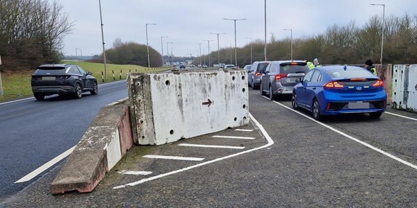 Taxis in a queue through a roadblock at Stansted