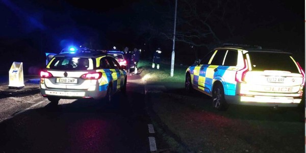 Police cars at night at the scene of the collision
