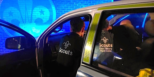 scout group being shown police vehicle.