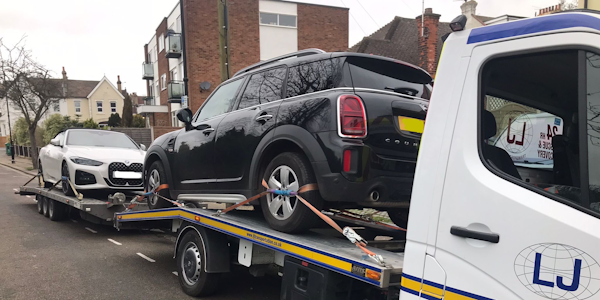 Two stolen recovered vehicles on back of transporter