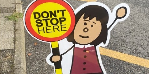 Cartoon girl holding lollipop warning sigh that says 'Don't Stop Here'.