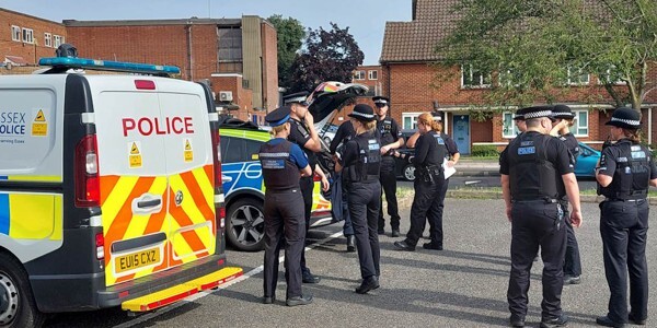 Eleven police officers with police car and police van in The Stow area of Harlow