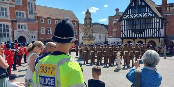 Police officer with crowds watching 33 Engineer Regiment parade in Saffron Walden town centre