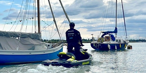 Officer patrolling on a personal water craft amongst sailing boats