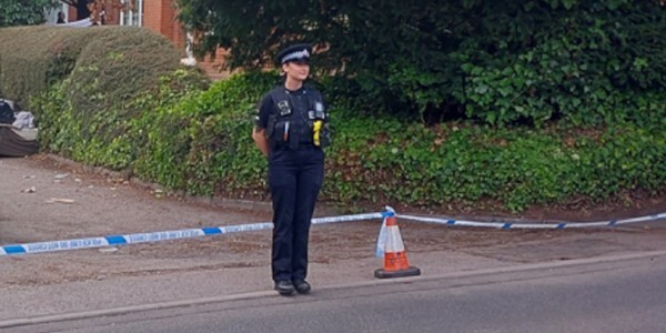 Officer guarding a scene cordon across entrance in Brentwood