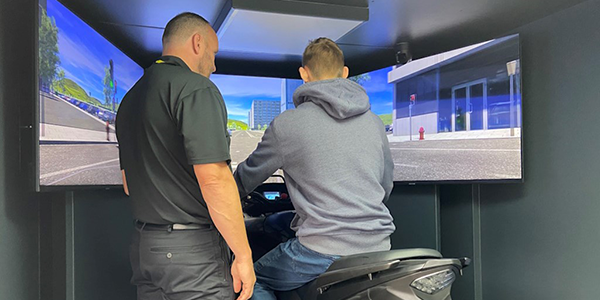 Student riding motorbike simulator