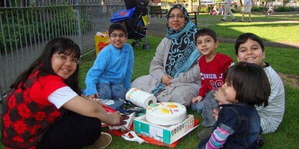 Members of the Shakoor family eating a picnic in a park