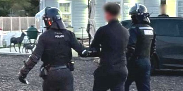 Man being arrested by two police officers