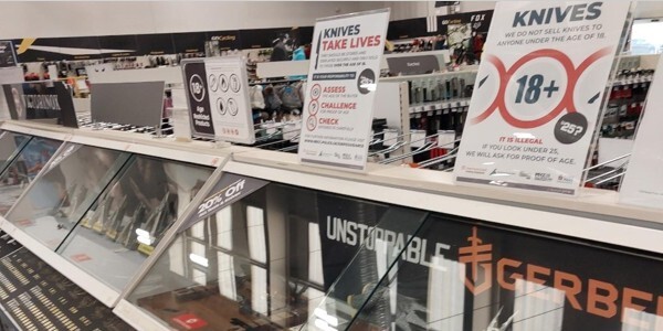 Warning signs on display in a shop where knives are sold
