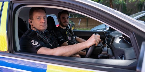 Chief Constable BJ Harrington in the driving seat of a police car