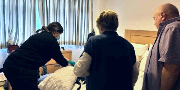 Sharon and Danny Brown with crime scene investigator in a bedroom