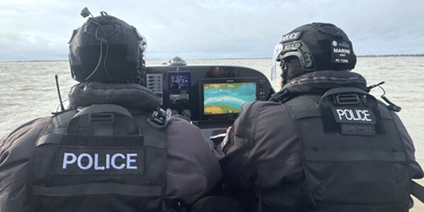 Two Marine Unit officers in a rigid inflatable boat on patrol