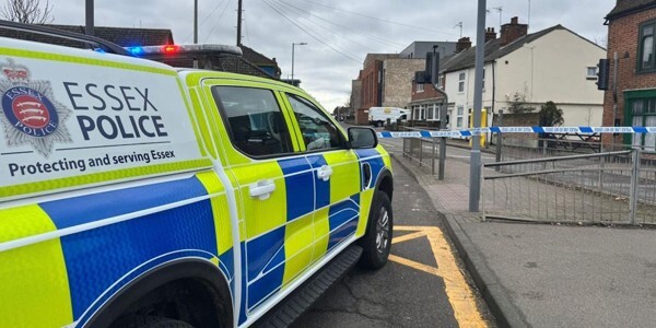 Essex Police vehicle parked near a cordon on Magdalen Street in Colchester
