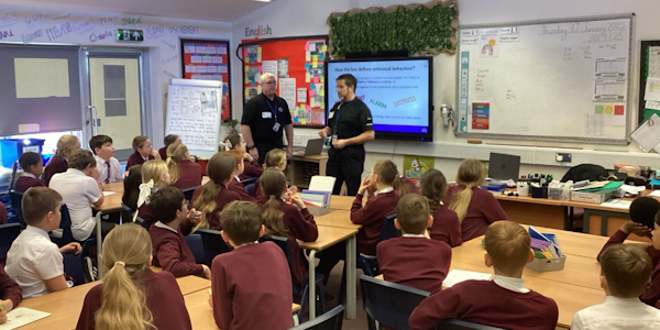 Officers giving ASB presentation to Year 6 students