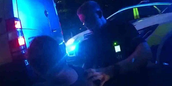 Officer arresting Christopher Searle