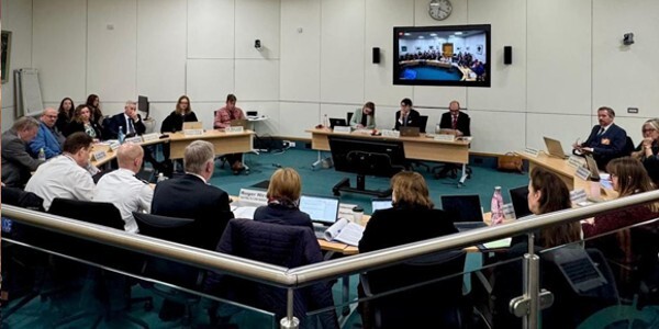Members of the Essex Police and Crime Panel in a large meeting room