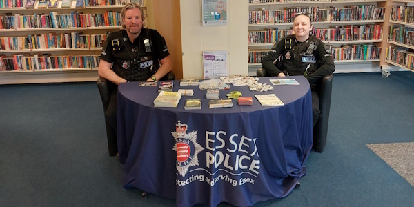 PC Davies and PC Osbourne sitting behind a table in the library 