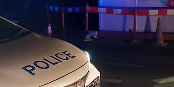 Police Car parked by road works